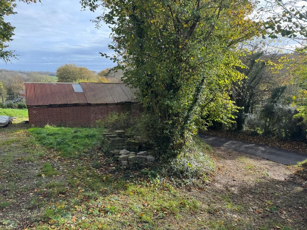 Lot: 98 - HALF AN ACRE AND BARN WITH POTENTIAL IN ATTRACTIVE SEMI-RURAL LOCATION - The Vehicular Access and Looking Down on the Barn